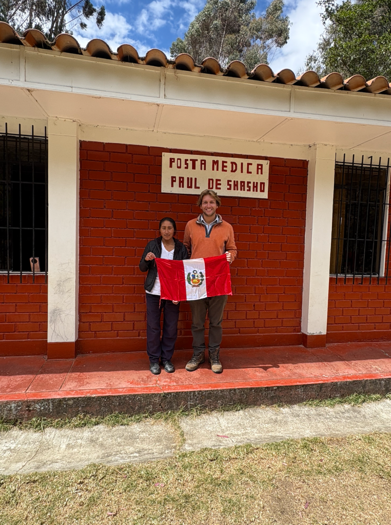 Noemi and Dan in front of the health post